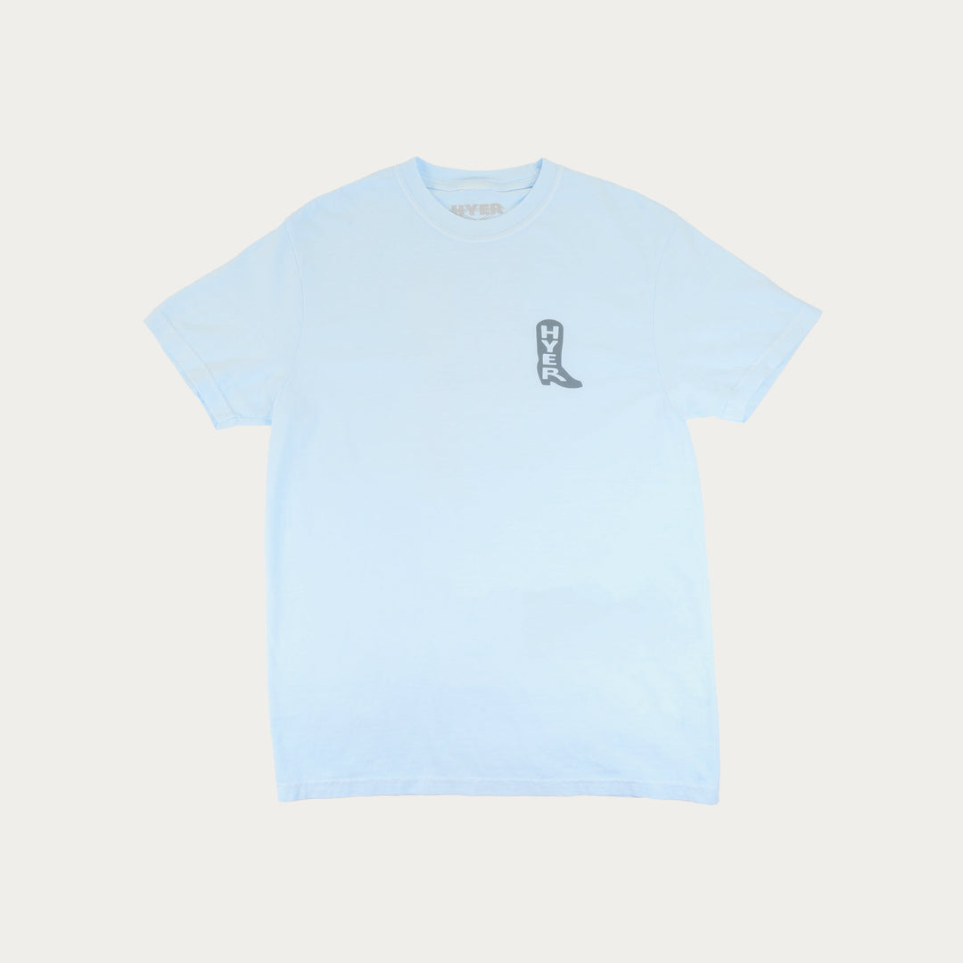 Light blue t-shirt with a small graphic on a light beige background