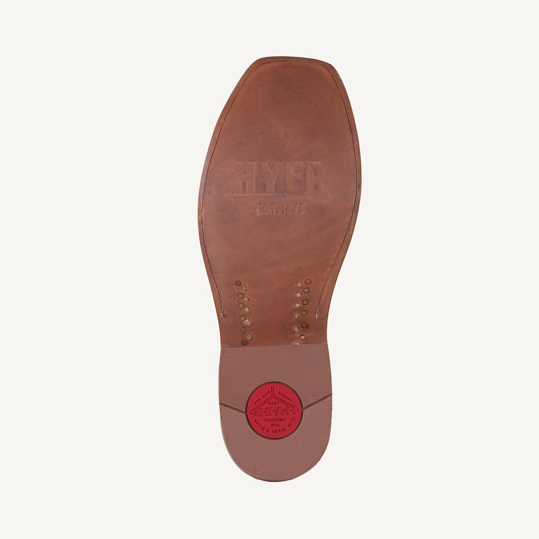 Brown leather shoe sole with a visible brand logo on a white background