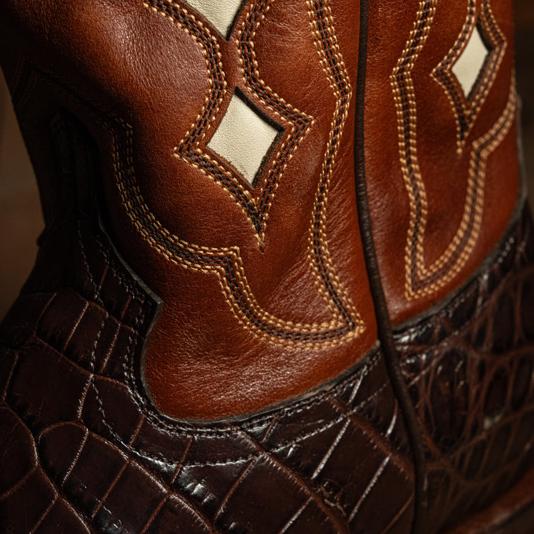 Close-up of brown leather boots with intricate stitching detail