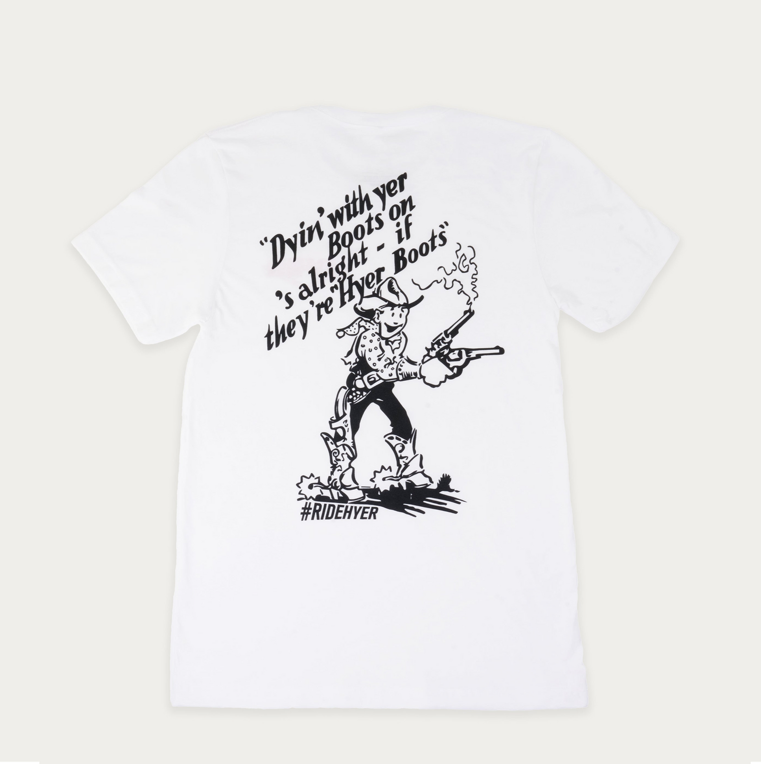 A white short-sleeve t-shirt with a black graphic print on the front. The graphic features a cowboy character, accompanied by the text 'Dyin' with yer Boots on's alright - if they're Hyer Boots' and the hashtag '#RIDEHYER'.