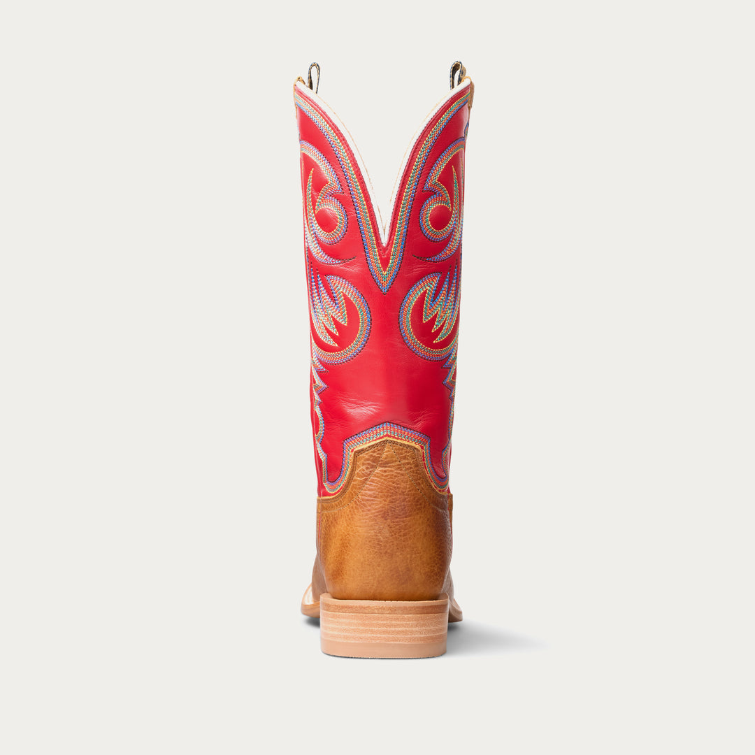 Red and brown cowboy boot with intricate patterns on a white background