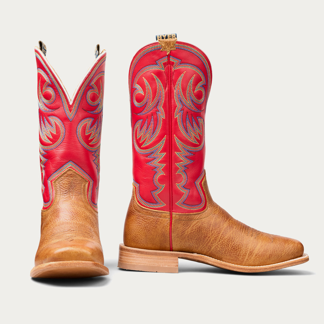 Red and brown cowboy boots with intricate designs on a light gray background