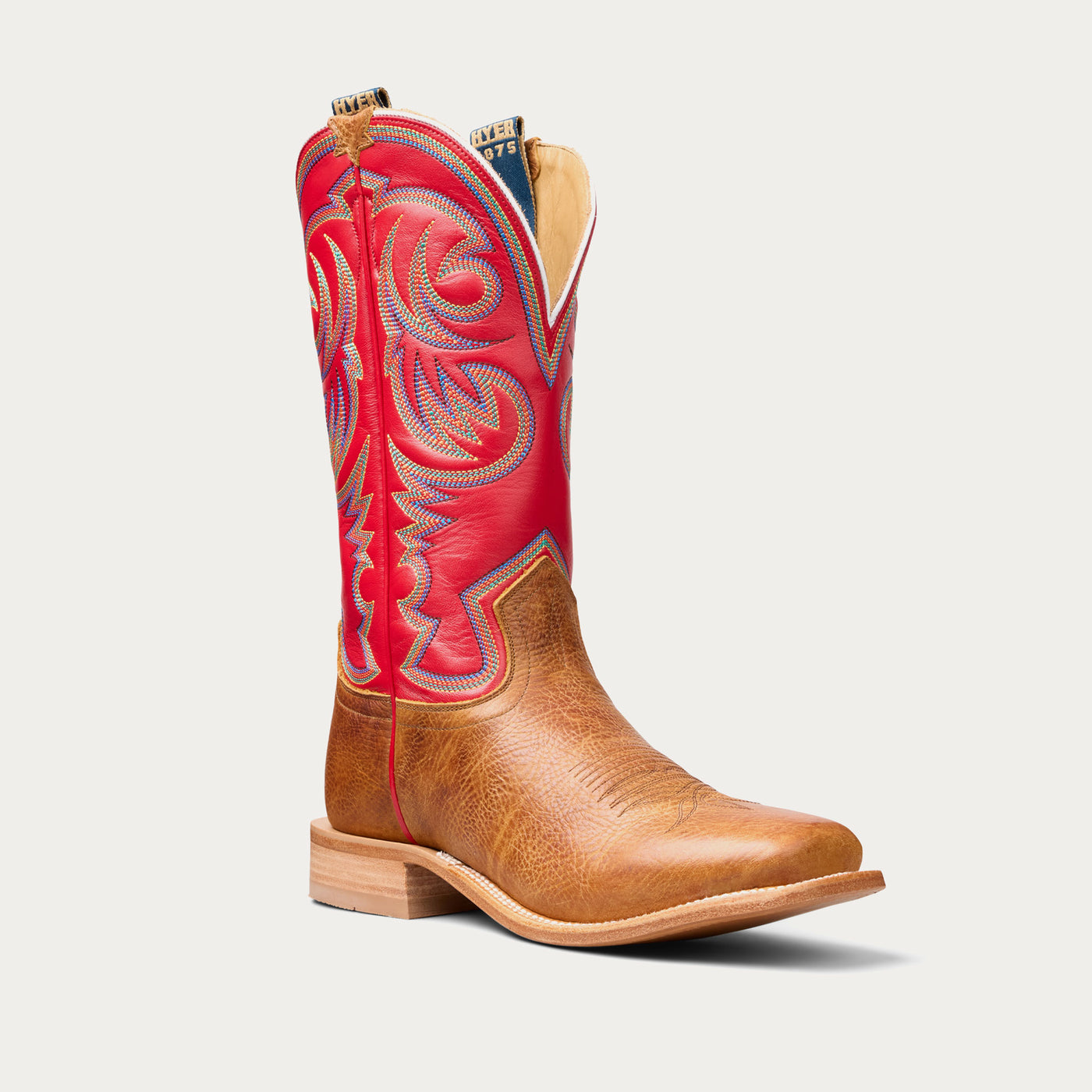 Brown cowboy boot with red upper on a white background