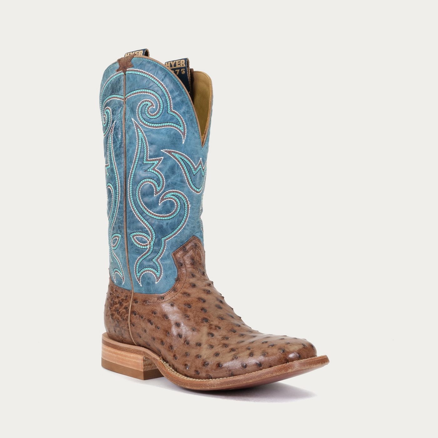 A brown and blue colored boot with an authentic ostrich vamp and a square toe.