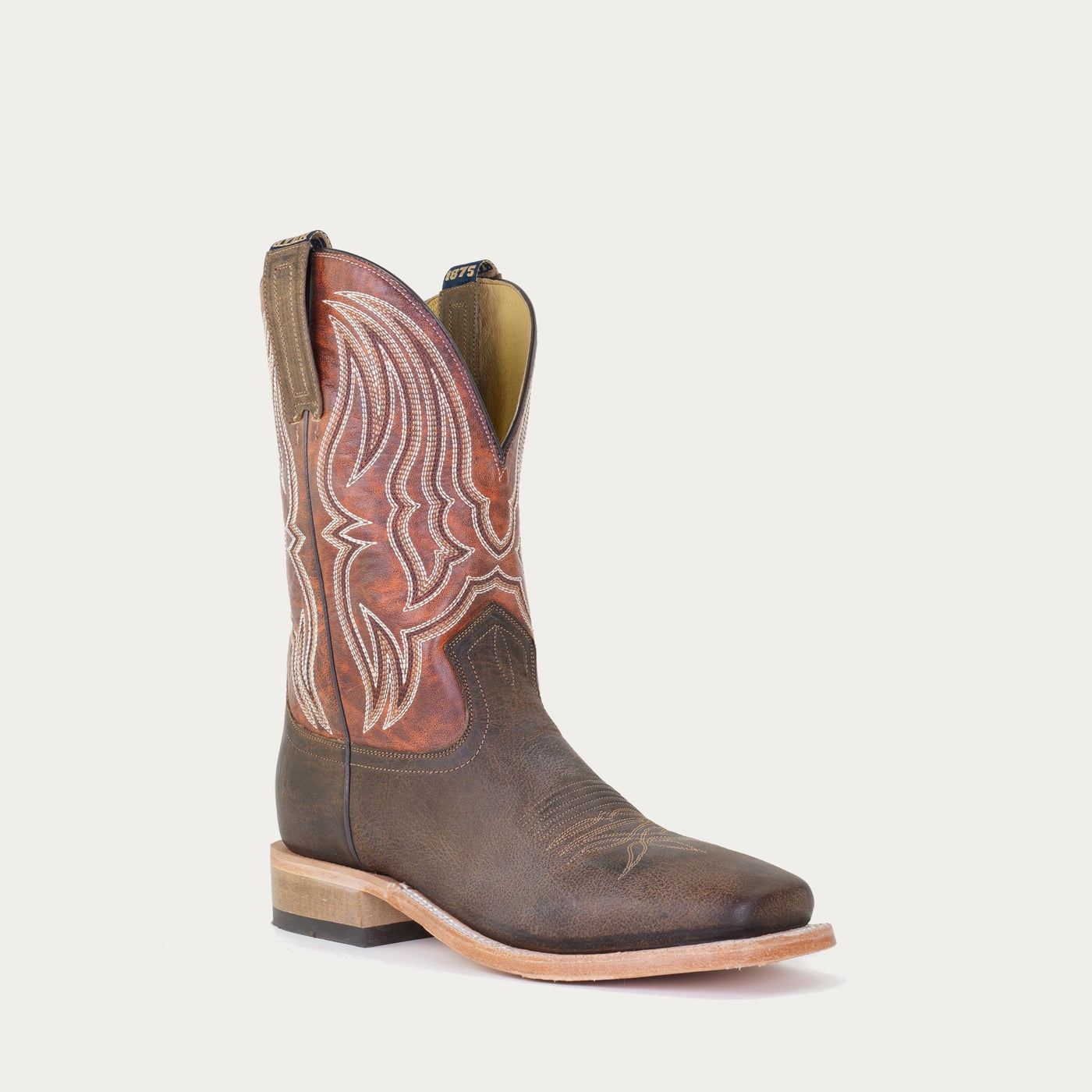 A brown and orange tinged brown men's cowboy boot with a square toe and low heel.
