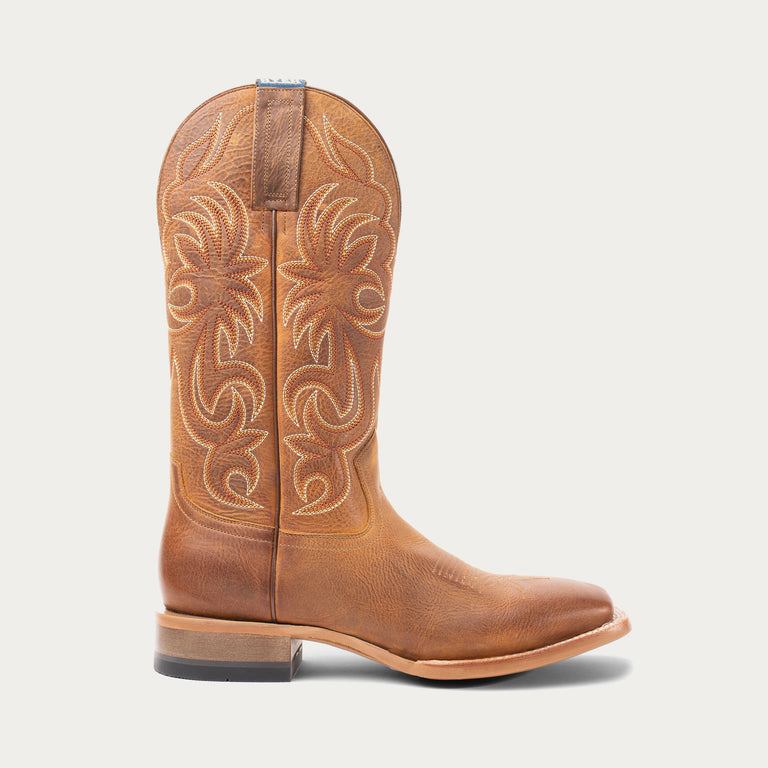 Brown cowboy boot with intricate white stitching on a light gray background