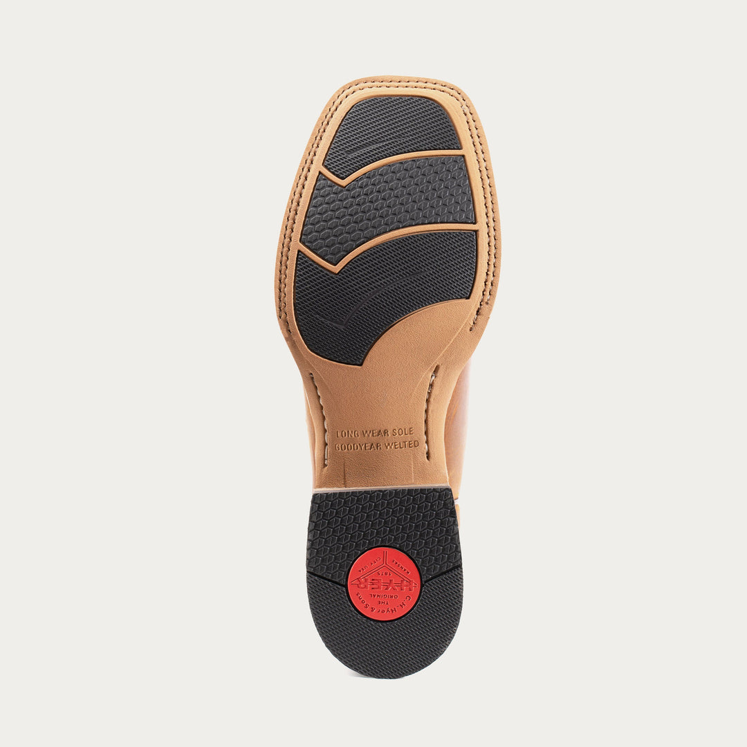 Shoe sole with black insole and red label on a light gray background