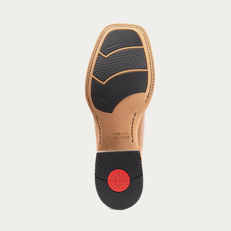 Shoe sole with black insole and red label on a light gray background