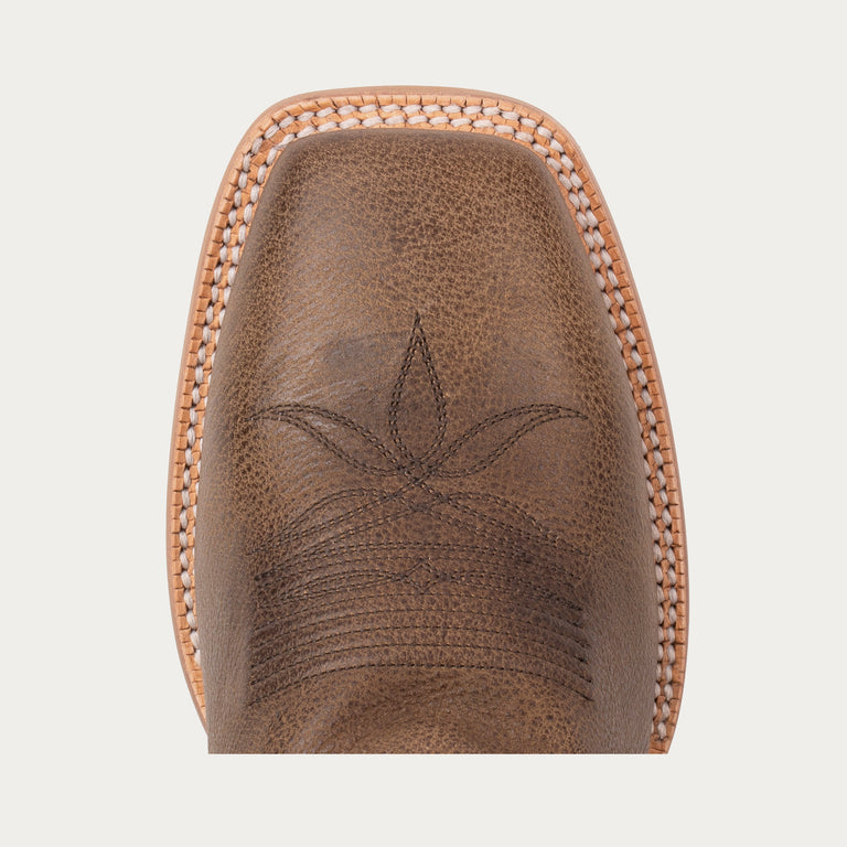 Brown leather boot sole with embossed design on a light gray background