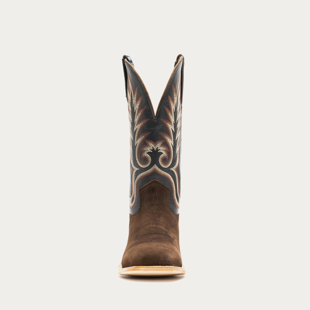 Brown and slate gray cowboy boot with decorative pattern on a light gray background