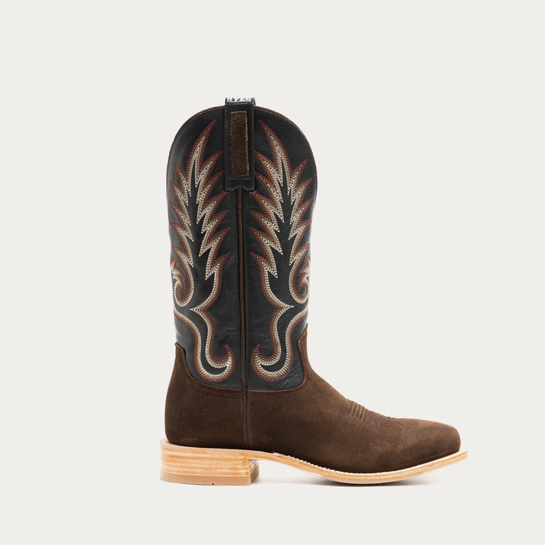 Brown and slate gray cowboy boot with intricate black and brown embroidery on a light gray background