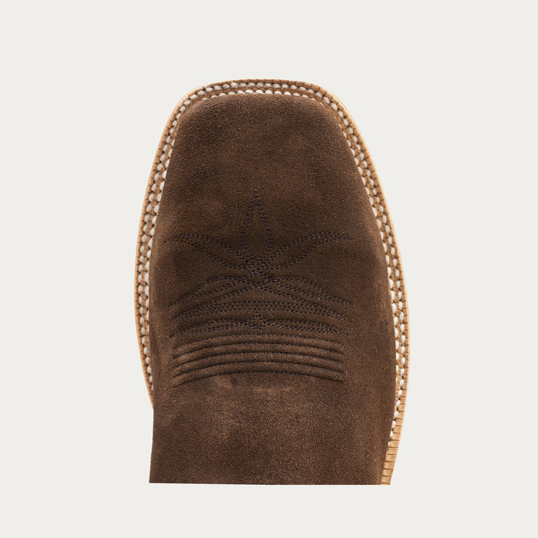 Close-up of a brown boot toe with stitching detail on a light gray background