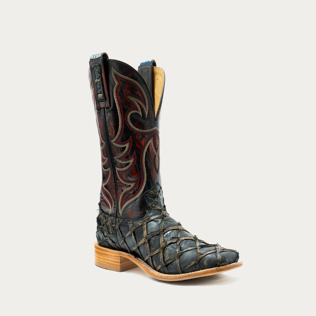 A single western cowboy boot with a dark charcoal brown big bass leather lower section, a black shaft, and red and gold embroidered western detailing, shown against a light gray background.