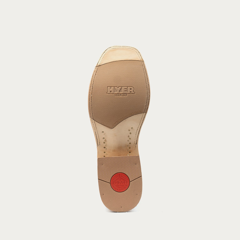 The outsole of a Hyer Leather cowboy boot, showing a tan leather sole with the 'HYER' brand name embossed in the center and a small red circular logo near the heel, on a light gray background.