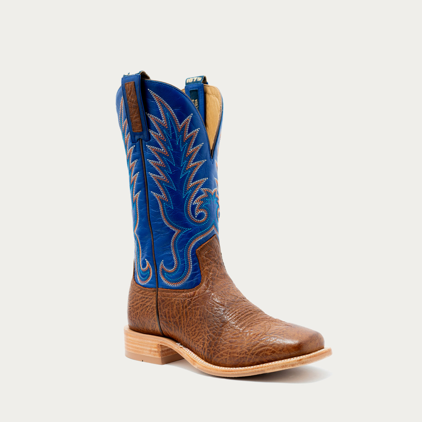A single western cowboy boot with a brown textured leather foot and a bright blue shaft featuring white embroidered stitching, shown against a light gray background.
