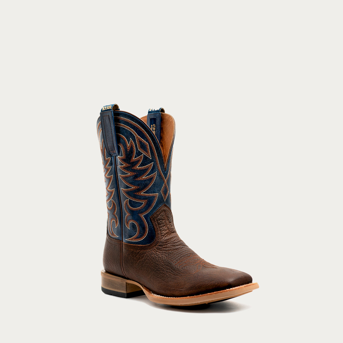 Brown and navy blue rubber sole cowboy boot on a white background