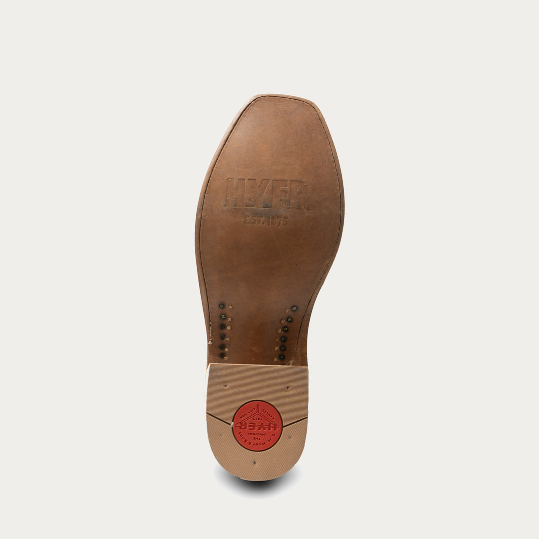 Brown leather shoe sole with 'Florsheim' branding on a light gray background