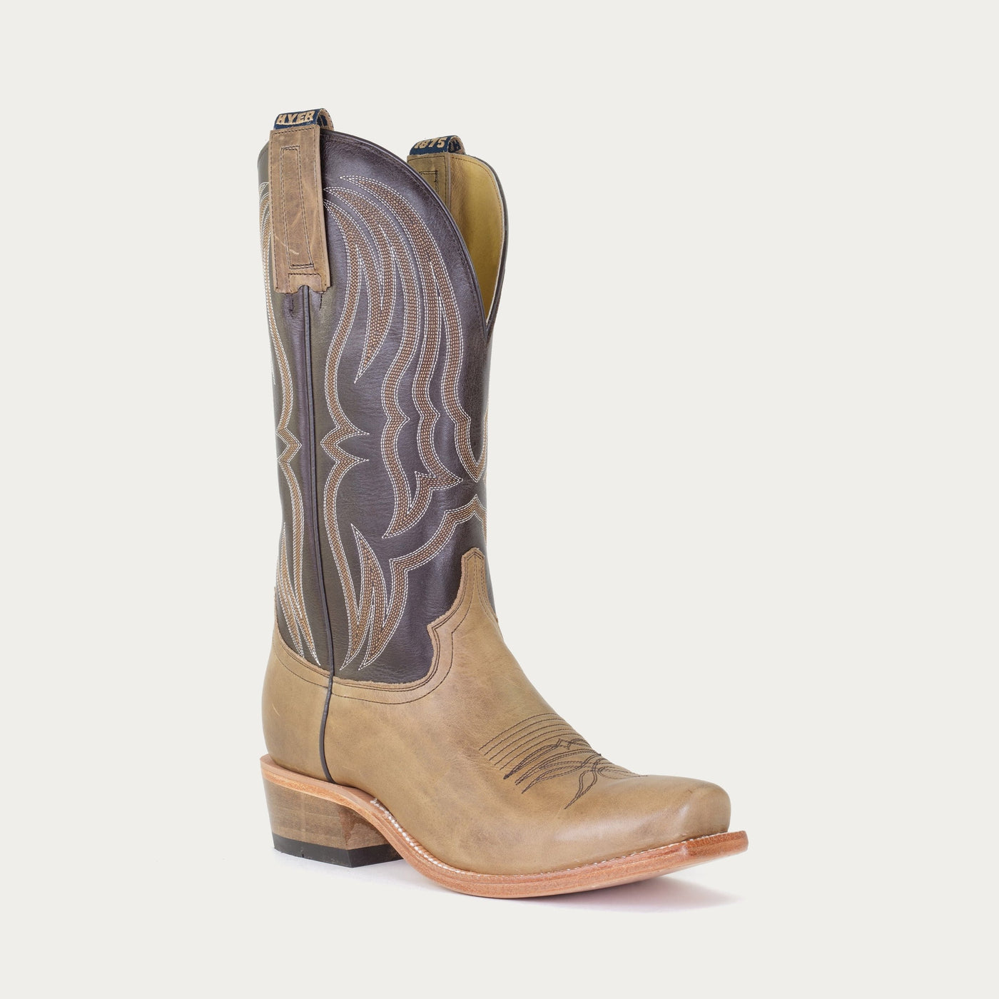 A brown and tan cowboy boot with a cutter toe 
