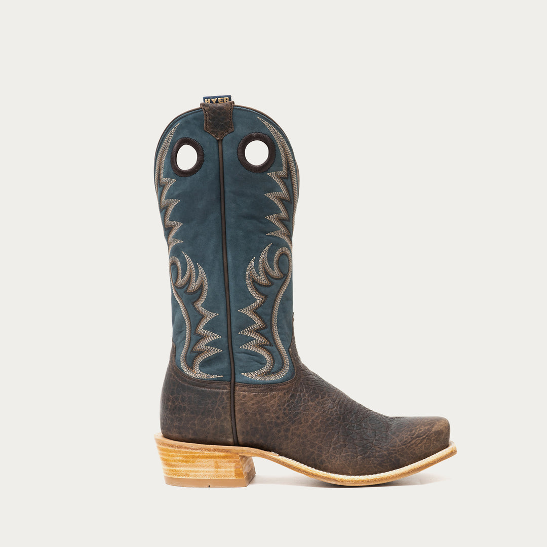 Blue and brown cowboy boot with blue accents on a gray background