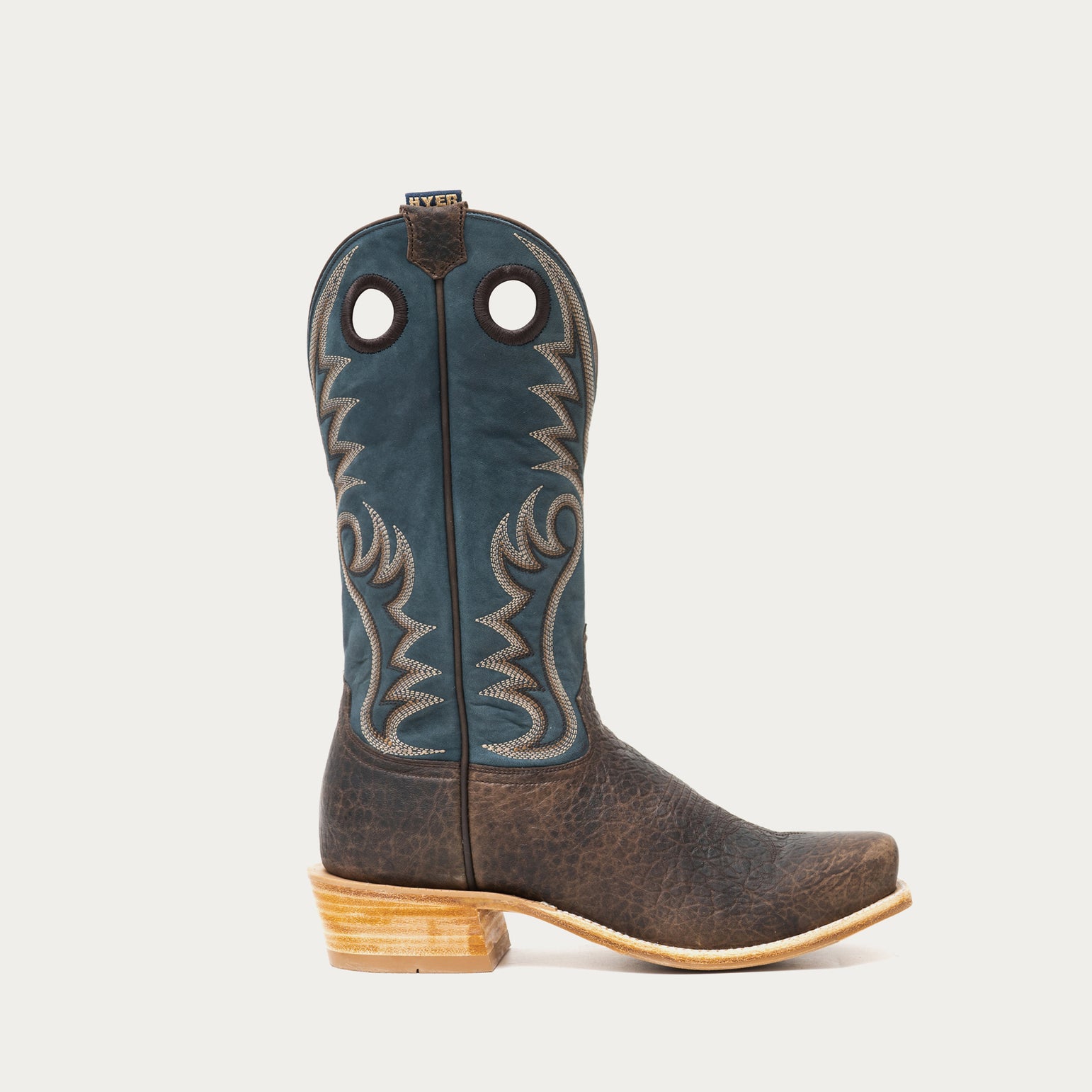 Blue and brown cowboy boot with blue accents on a gray background