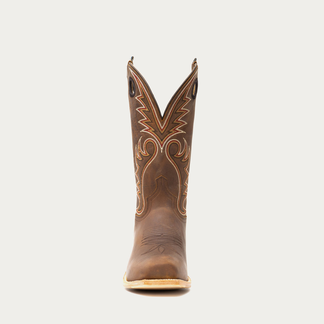 Brown cowboy boot with intricate stitching on a light gray background