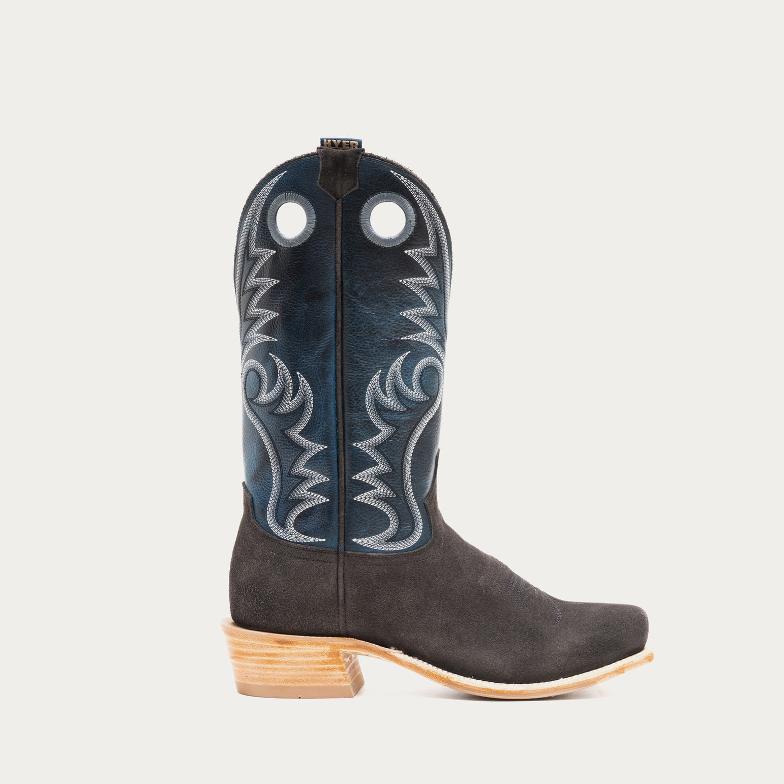 Blue and charcoal gray cowboy boot with blue embroidered design on a light gray background