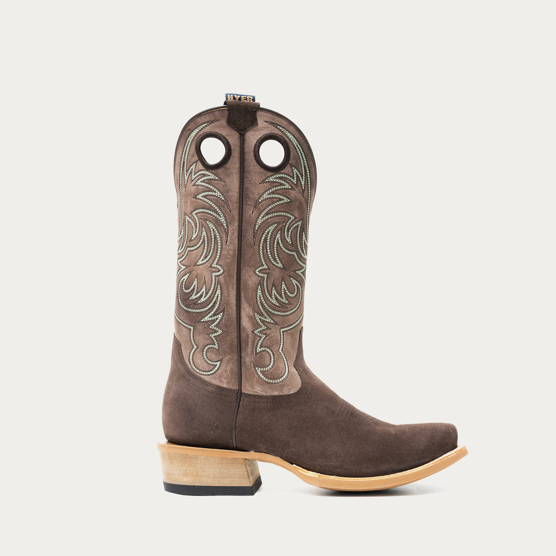 Chocolate brown and taupe cowboy boot with brown and light blue intricate stitching on light gray background