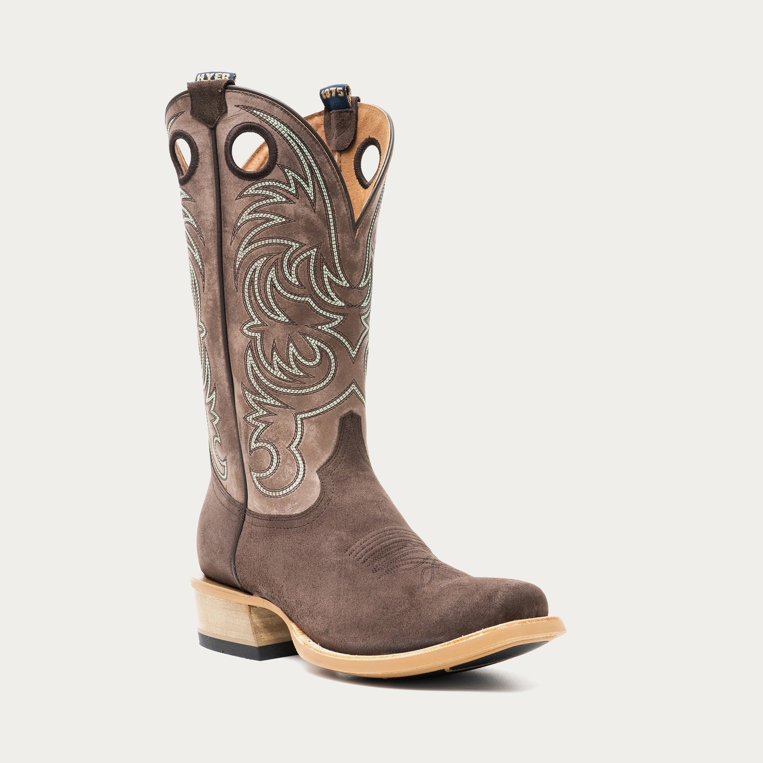 Chocolate brown and taupe cowboy boot with brown and light blue intricate stitching on light gray background
