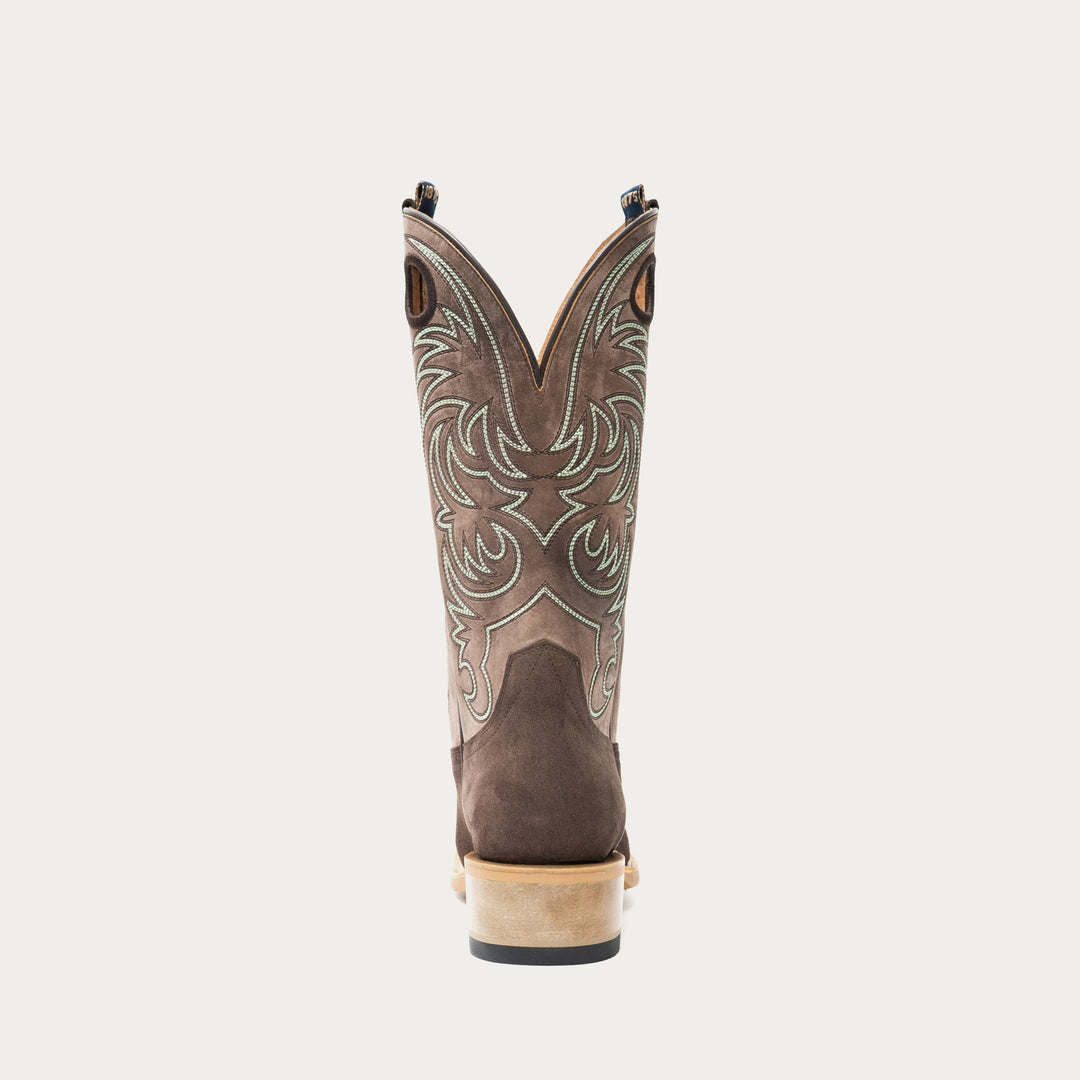 Chocolate brown and taupe cowboy boot with brown and light blue intricate stitching on light gray background