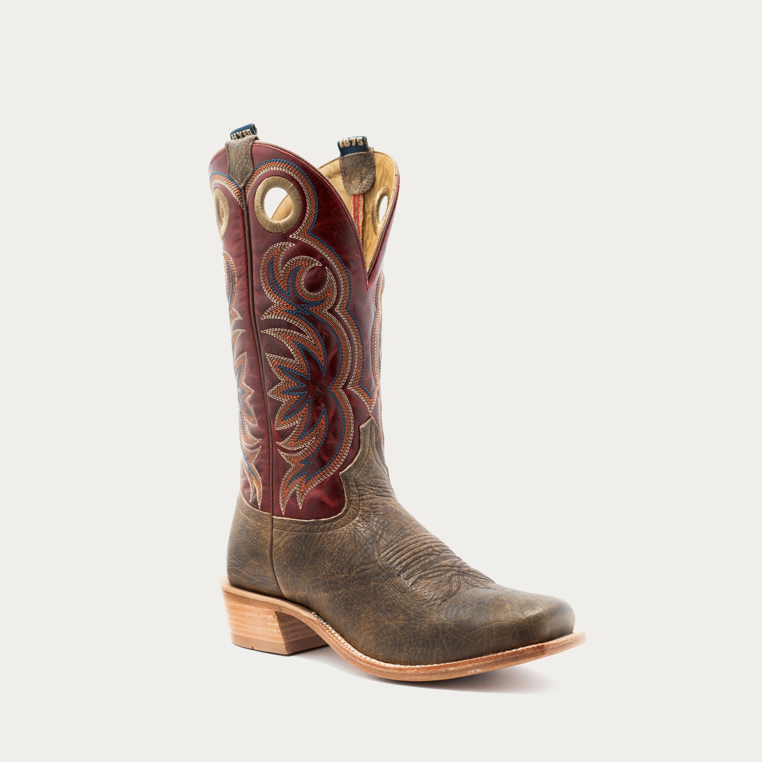 A single western cowboy boot with a distressed brown leather lower body and a dark red embroidered shaft, shown against a light gray background.