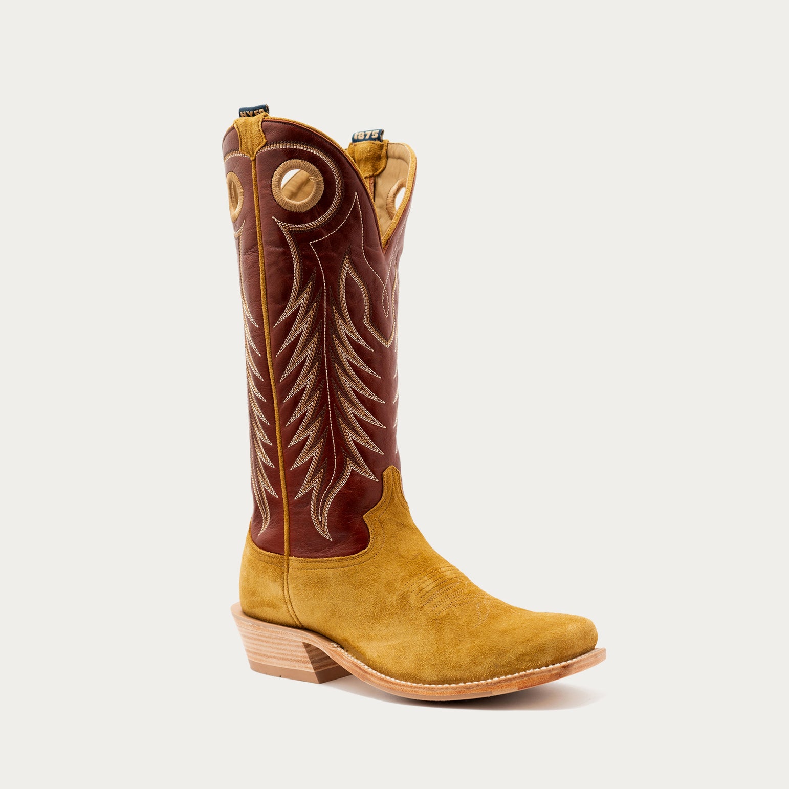 A single mid-calf western cowboy boot with a tan suede body, a dark bronze shaft, and light tan embroidery, shown from a side profile on a light gray background.