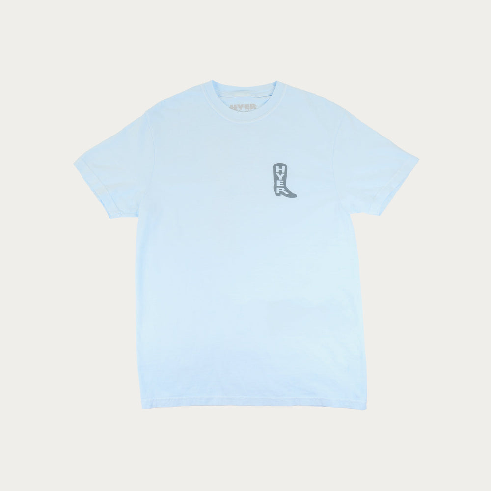 Light blue t-shirt with a small graphic on a light beige background