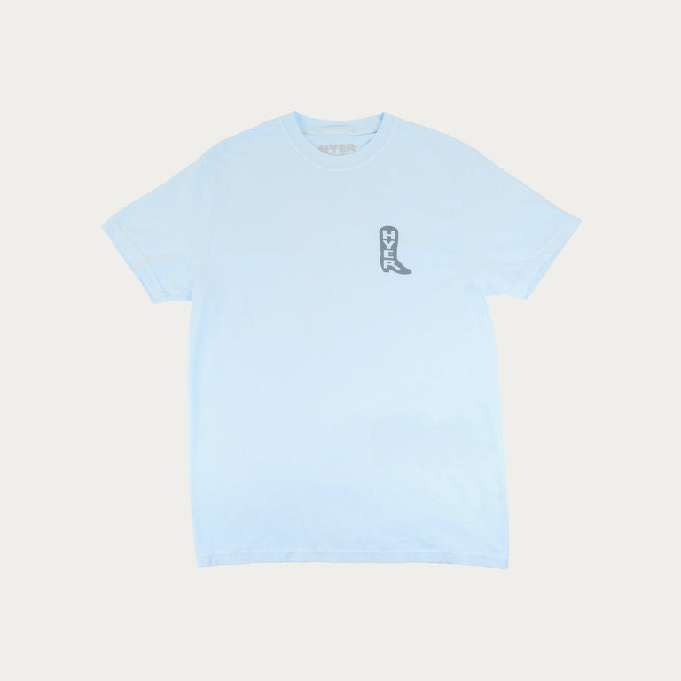 Light blue t-shirt with a small graphic on a light beige background