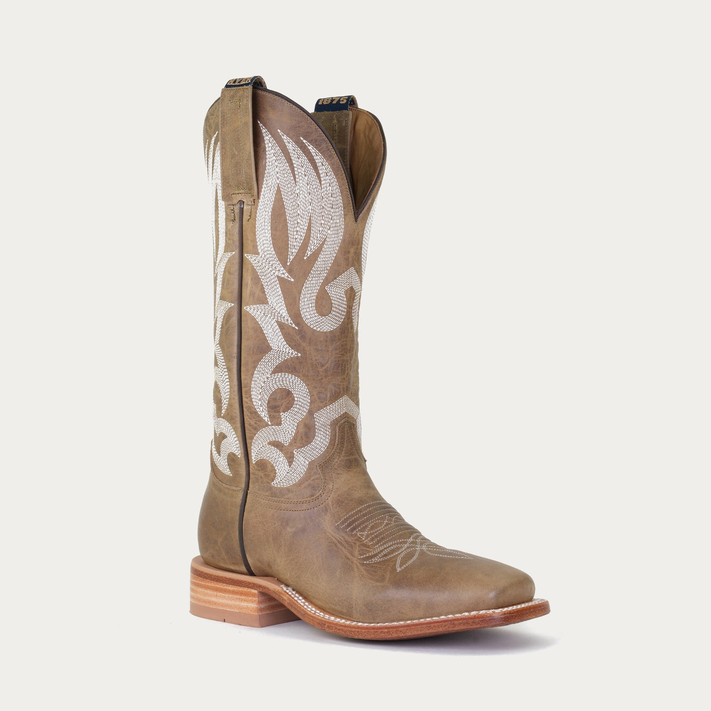 A brown cowboy boot with white stitching patterns on the upper shaft and a square toe.