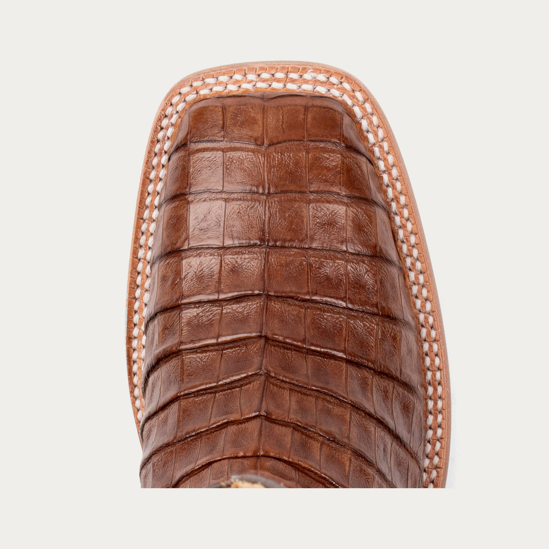 Close-up of a brown leather boot sole with woven pattern on a light gray background