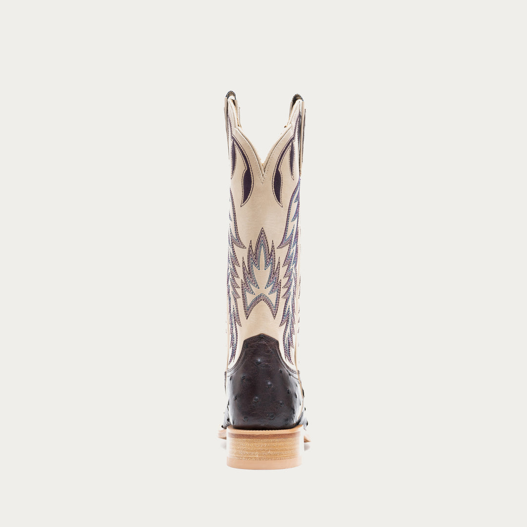 Off white and dark purple cowboy boot with decorative pattern on a light gray background