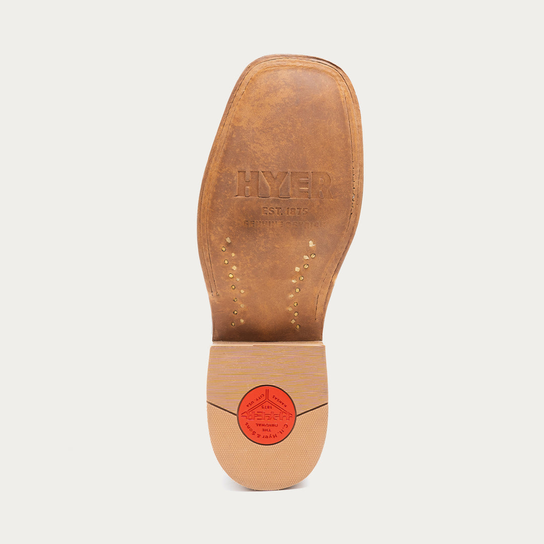 Brown leather insole with 'HYER' branding on a light gray background