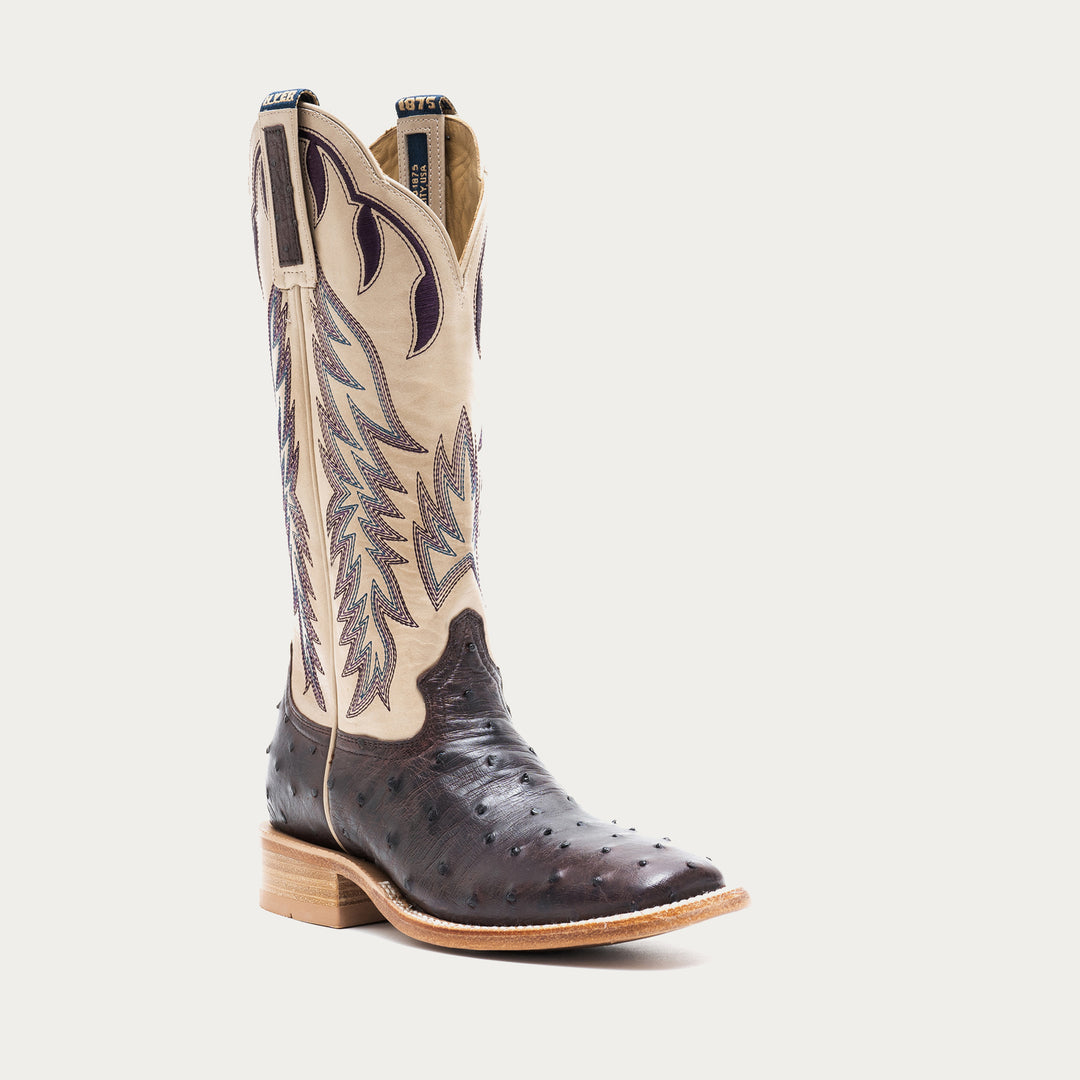 Off white and dark purple cowboy boot with detailed design on a light gray background