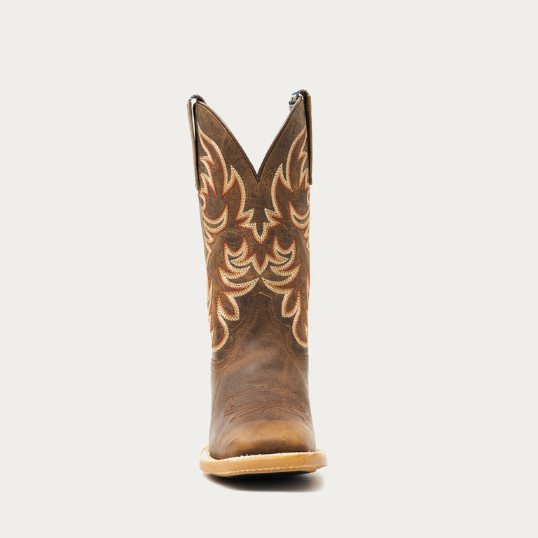 Brown cowboy boot with intricate design on a light gray background