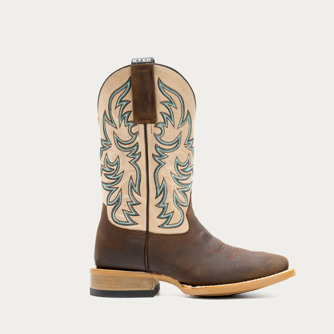 Brown and off white cowboy boot with intricate brown and blue embroidery on a light gray background