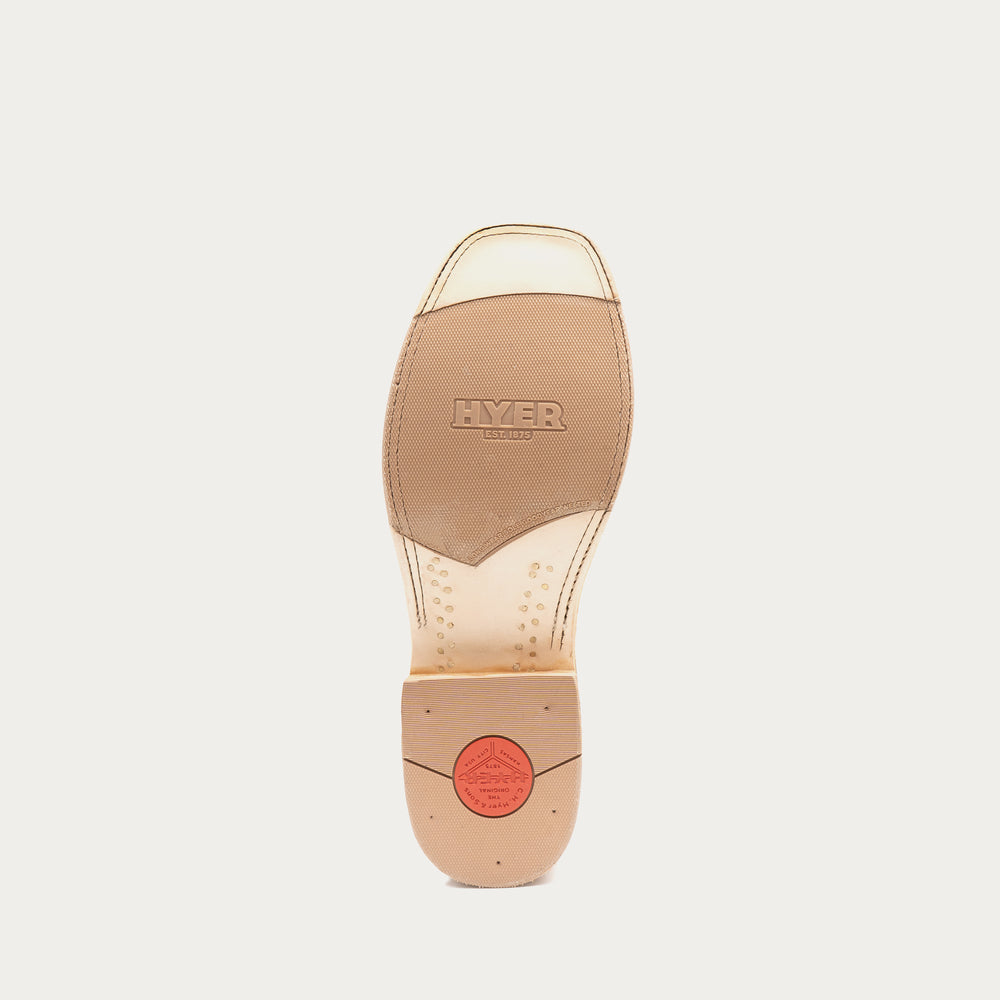 The outsole of a Hyer cowboy boot, showing a tan leather insole with the brand name embossed and a red circular logo near the heel, on a light gray background.