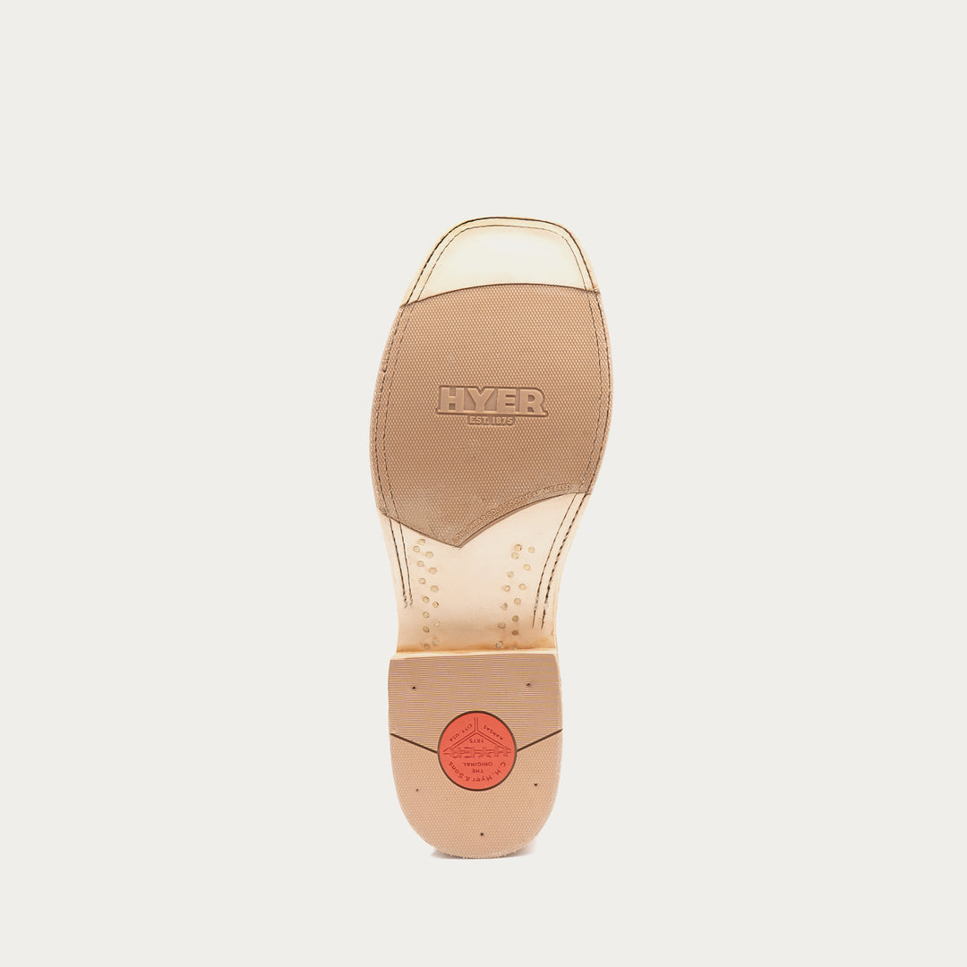 The outsole of a Hyer cowboy boot, showing a tan leather insole with the brand name embossed and a red circular logo near the heel, on a light gray background.