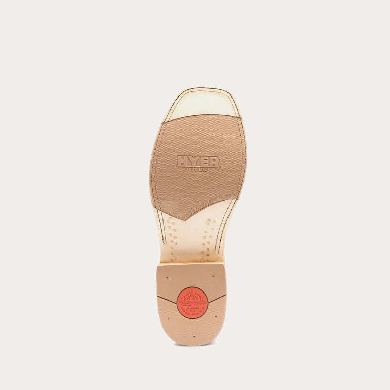 The outsole of a Hyer cowboy boot, showing a tan leather insole with the brand name embossed and a red circular logo near the heel, on a light gray background.