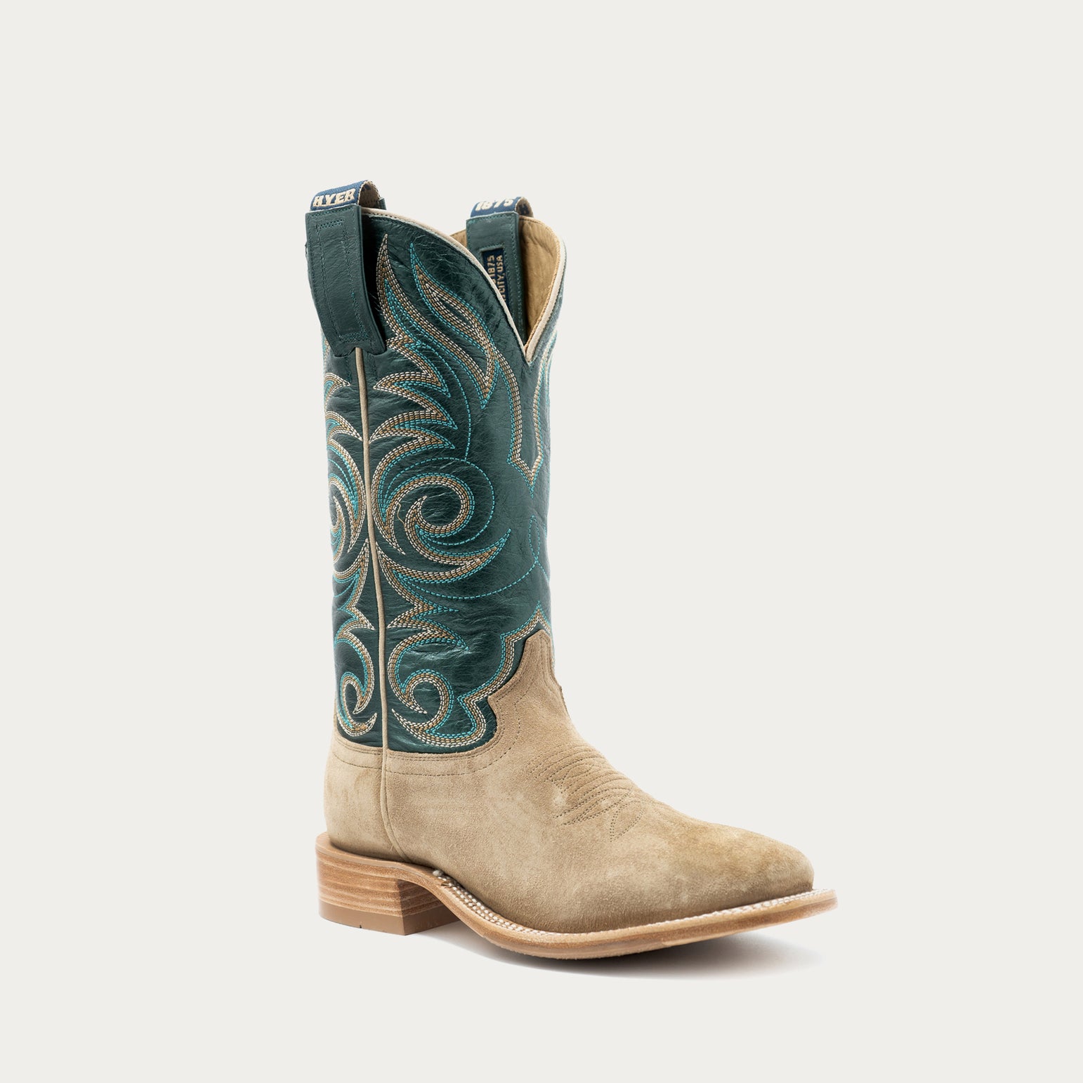 A single western cowboy boot shown in profile against a light gray background. The boot has a tan suede lower body and a dark teal shaft with ornate embroidered swirl patterns in teal and light tan.