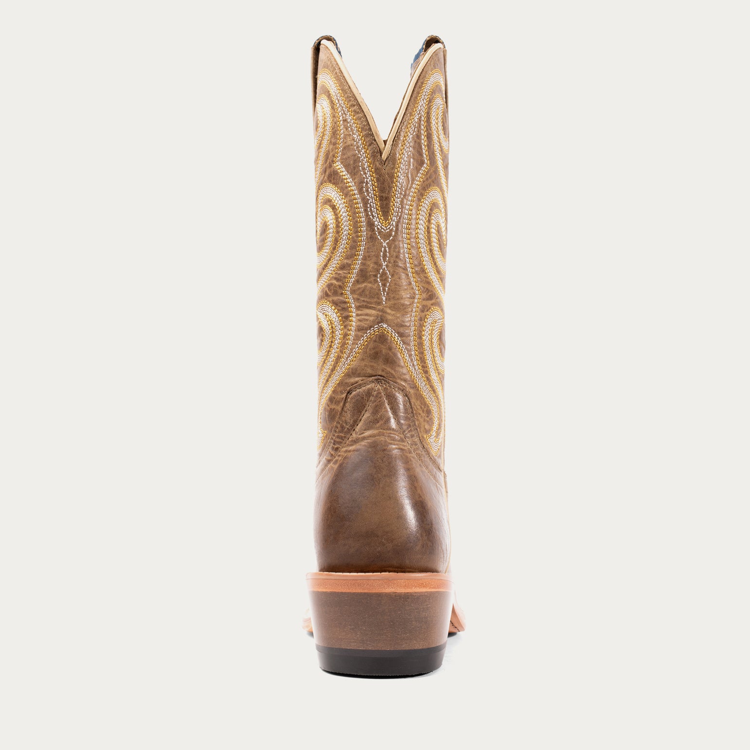 Brown cowboy boot with intricate stitching on a light gray background