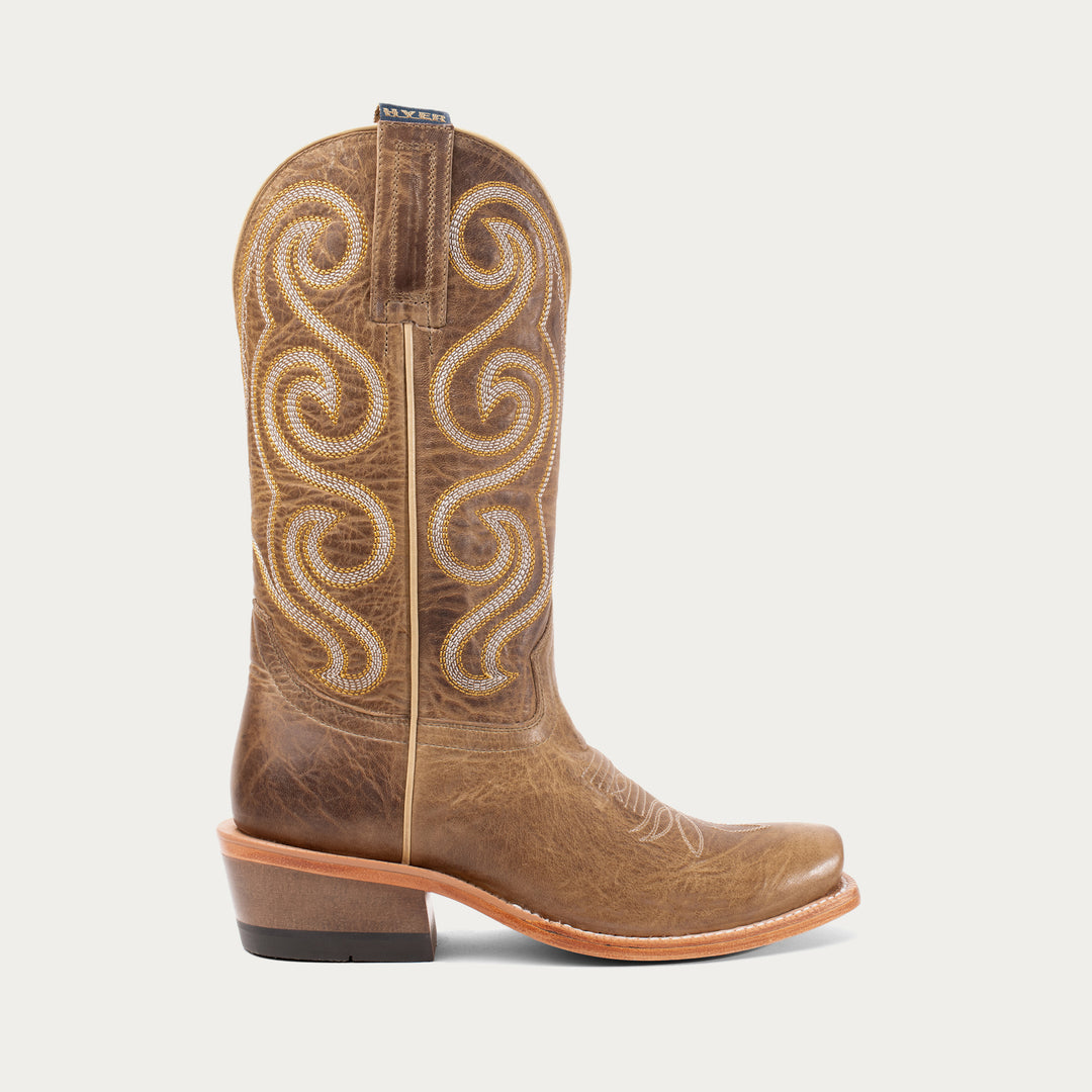 Brown cowboy boot with intricate white stitching on a light gray background