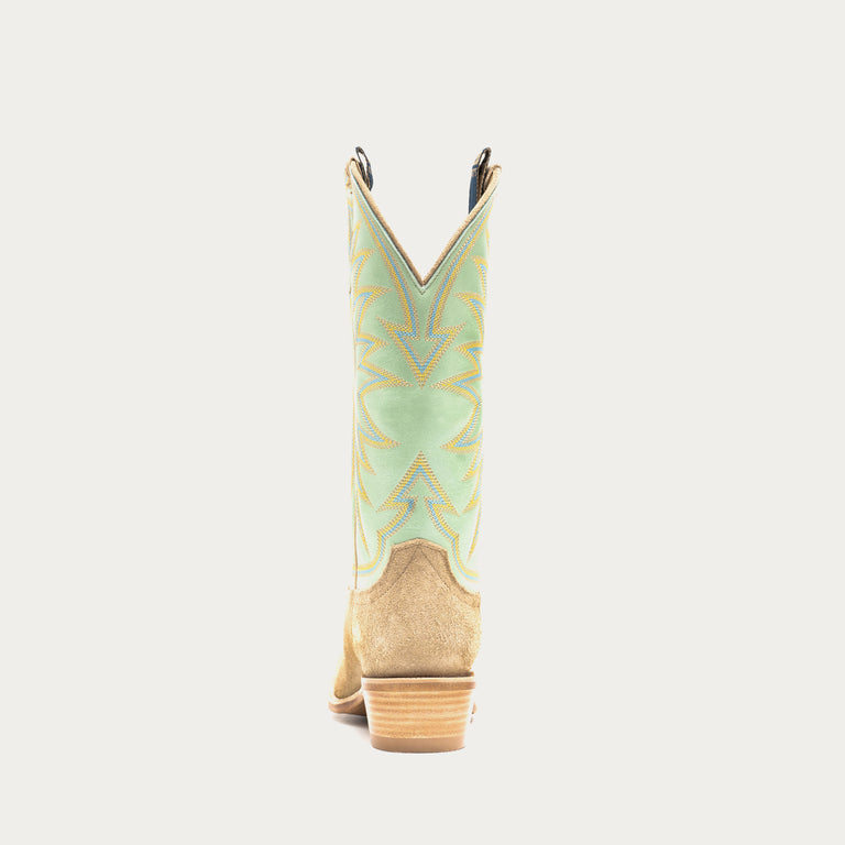 Light green and tan cowboy boot with tan sole on a gray background