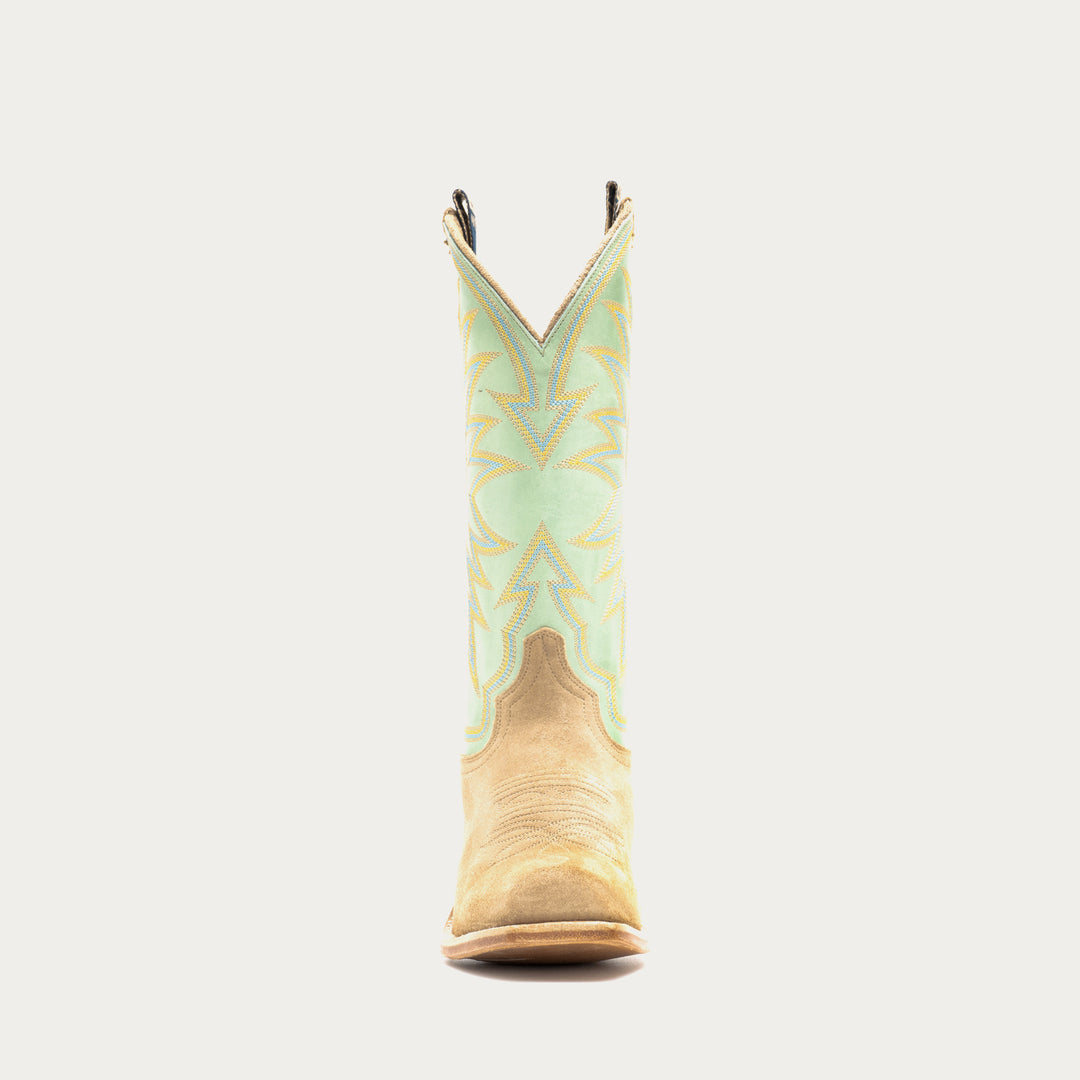 Cowboy boot with a patterned design on a gray background