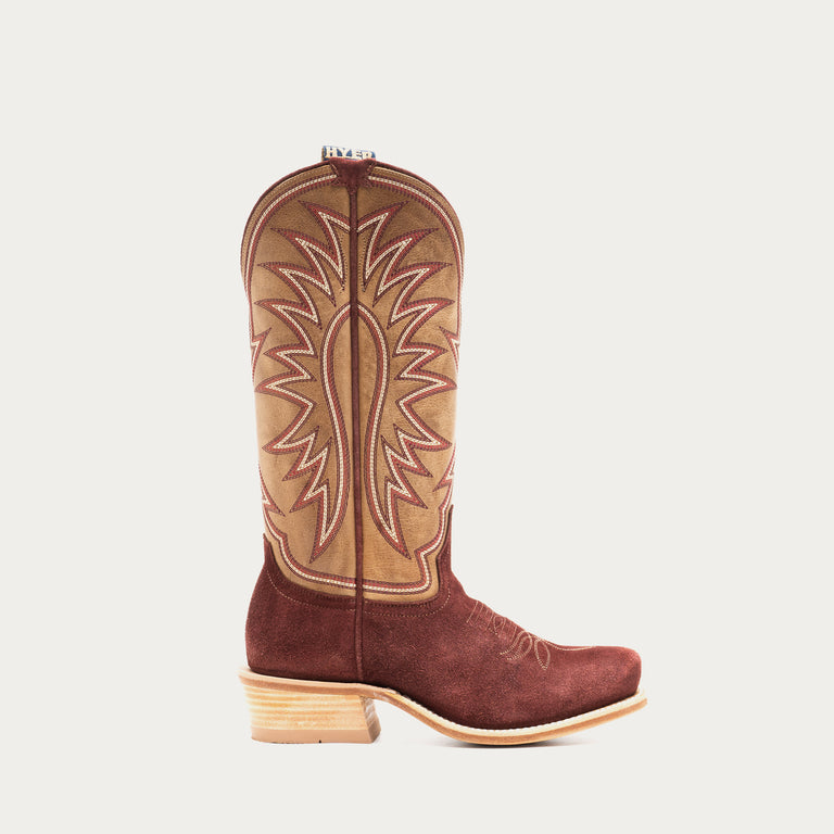Burgundy and tan cowboy boot with tan interior on a light gray background