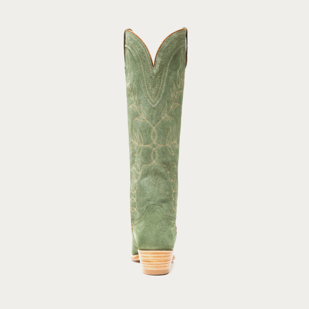 Tall green cowboy boot on a light gray background